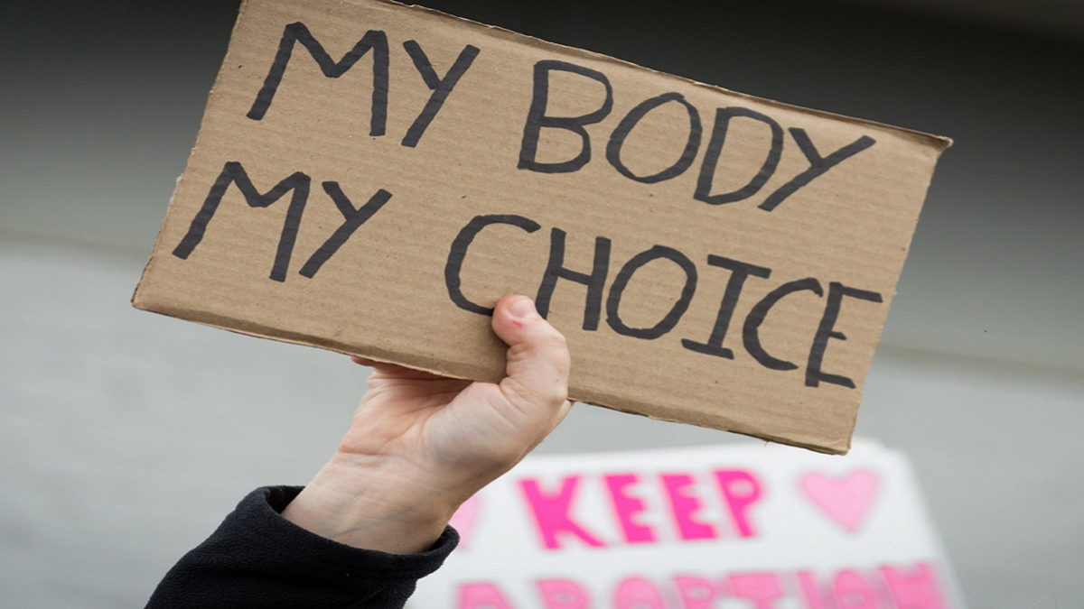 hand holding sign: body my choice