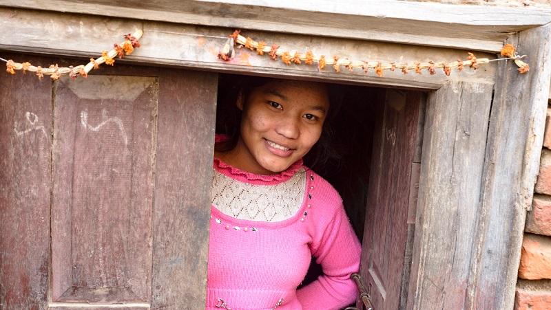 girl smiles in a doorstep