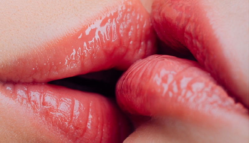 close up on two female lips kissing