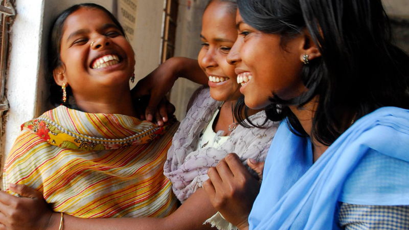 three girls laughing together