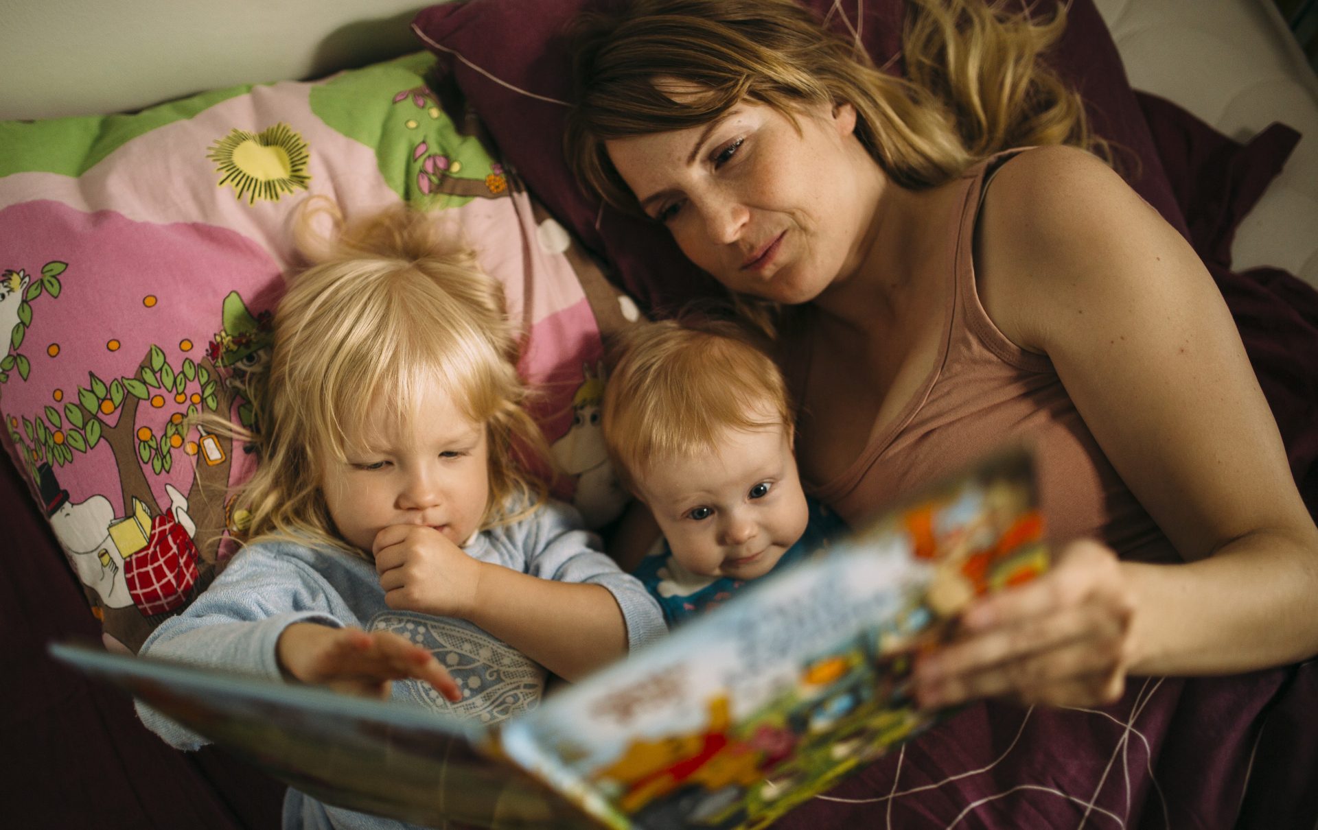 Mother reading to her children.