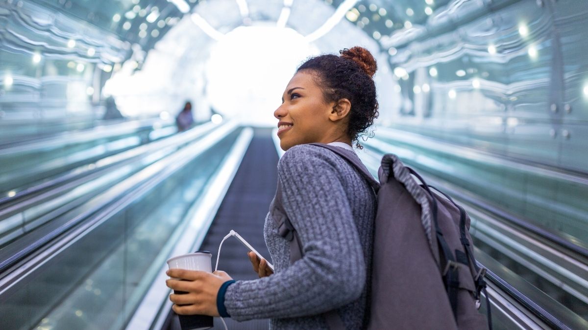 A young smiling woman in the escalator.