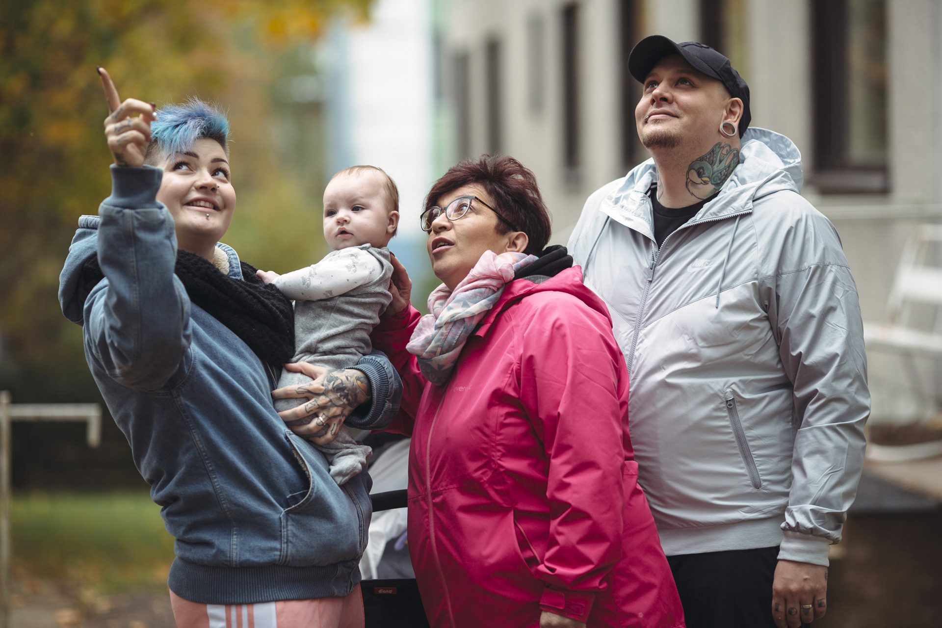 Three generations together outdoors. Mom, dad, baby and grandmother.